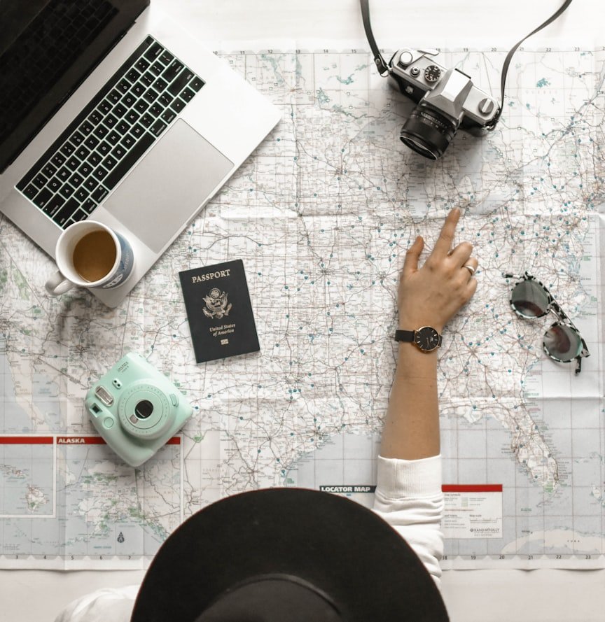 Person pointing at a map (Unsplash photo)