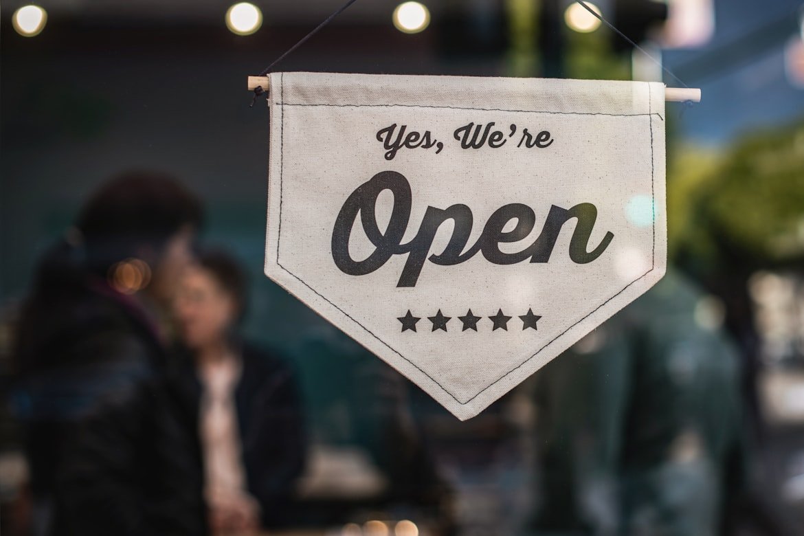 Small business storefront with open sign displaying entrepreneurship and business formation